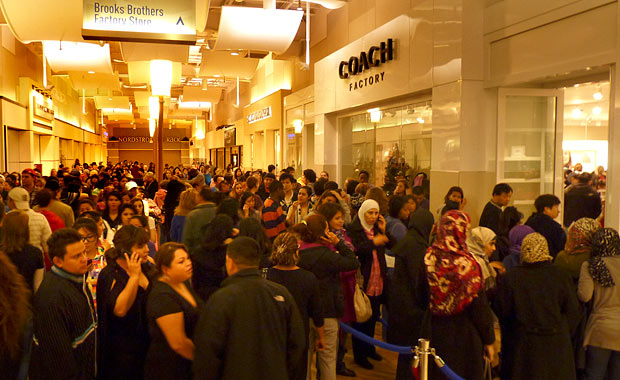 Crowds line up outside the Coach store at Potomac Mills at about 12:30 ...